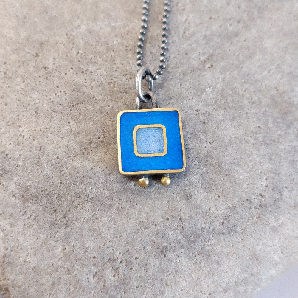 Necklace - bright blue and lilac blue square with two gold balls. 
